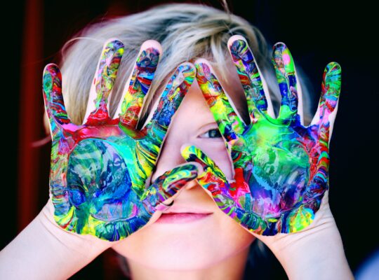 kid with colorful hands